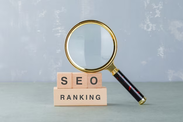 Magnifying glass on wooden cubes with the word SEO ranking