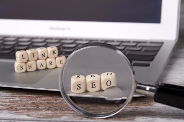 Wooden cubes with letters on the laptop and magnifying glass