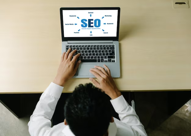A man works at a laptop and creates an SEO strategy