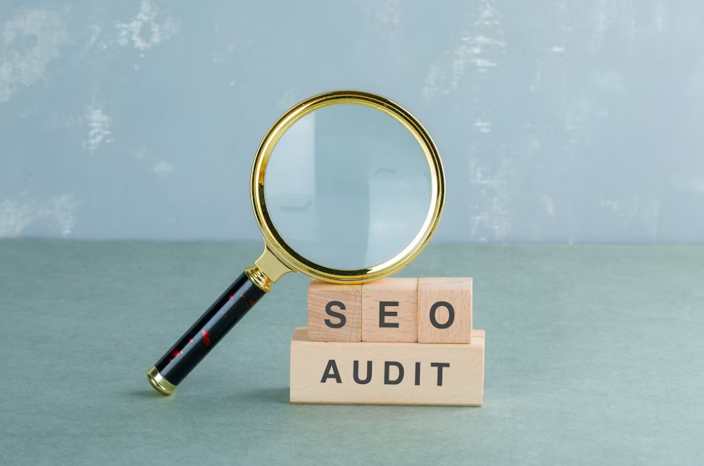 magnifying glass on wooden cubes, SEO audit written on it