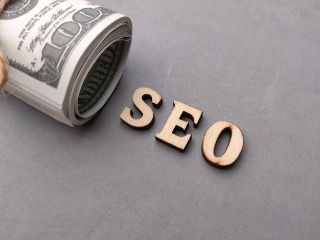 Banknotes and wooden word seo search engine optimization on a gray background